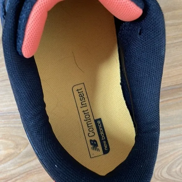 Black and orange New Balance tennis shoes
