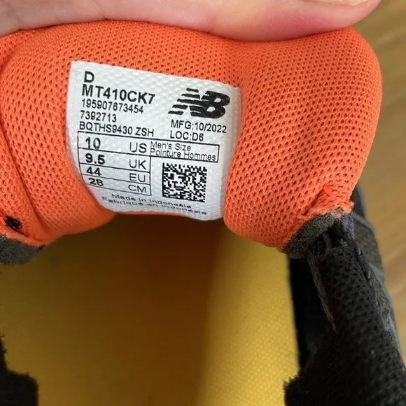 Black and orange New Balance tennis shoes