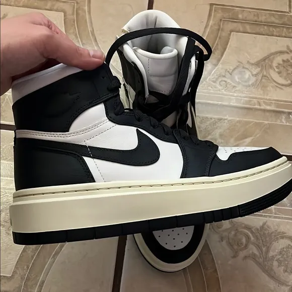 Nike women’s Black and White High-Top Sneakers
