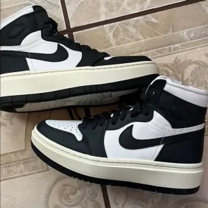 Nike women’s Black and White High-Top Sneakers