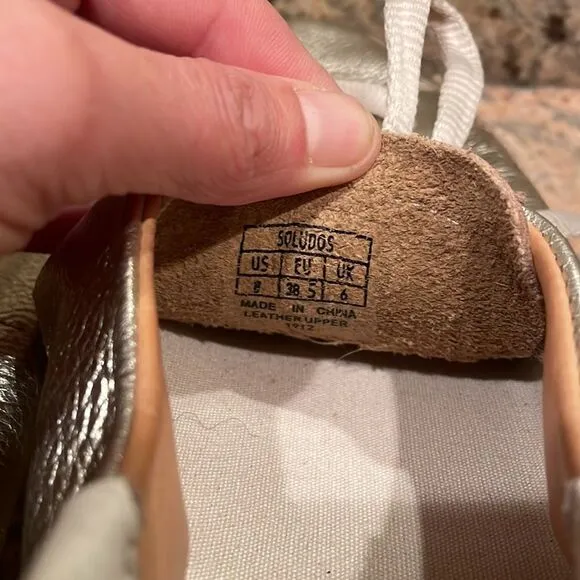 Soludos woman’s gold sparkly tennis shoes