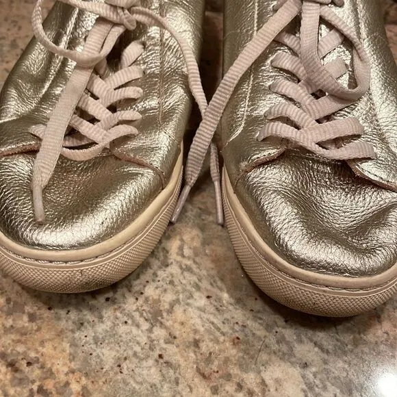 Soludos woman’s gold sparkly tennis shoes