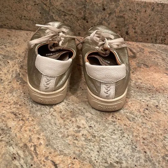 Soludos woman’s gold sparkly tennis shoes