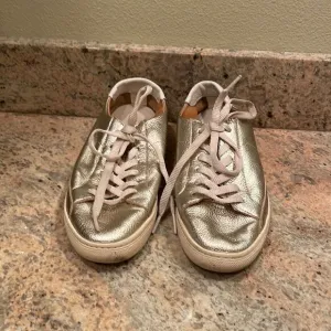 Soludos woman’s gold sparkly tennis shoes
